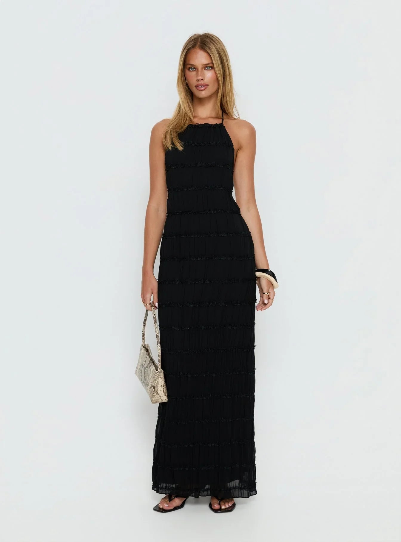 Black Halter Prom Dress with Tiered Ruffle Detail and Open Back for Formal Events and Prom Nights
