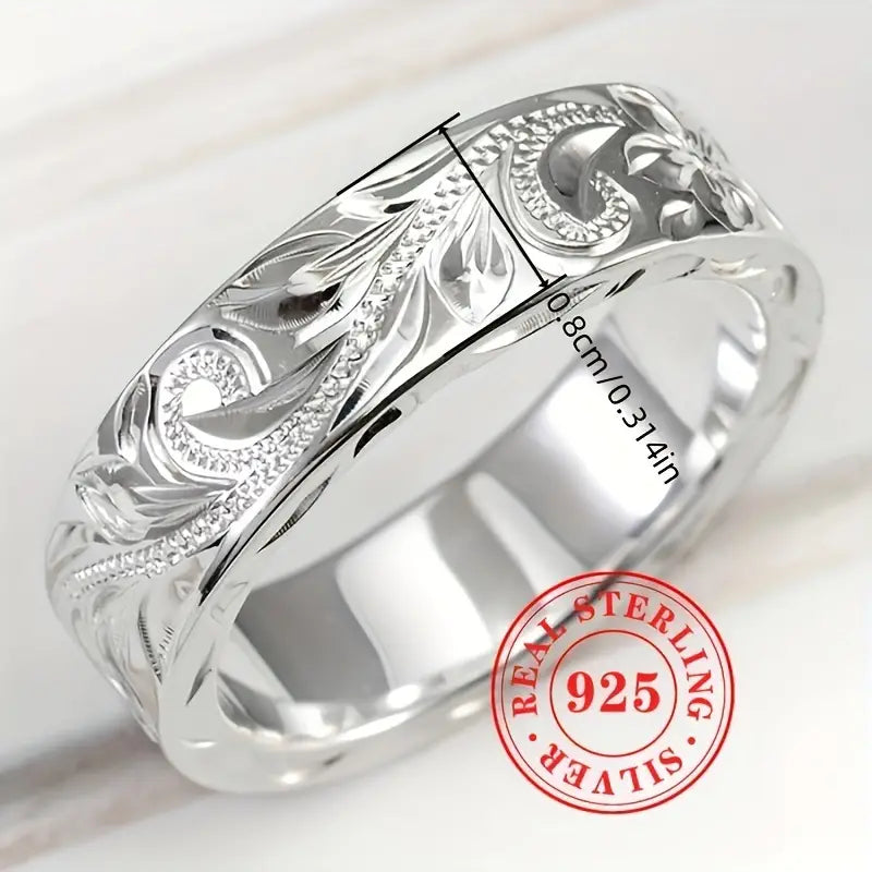 Close-up of carved leaf and flower details on sterling silver ring.