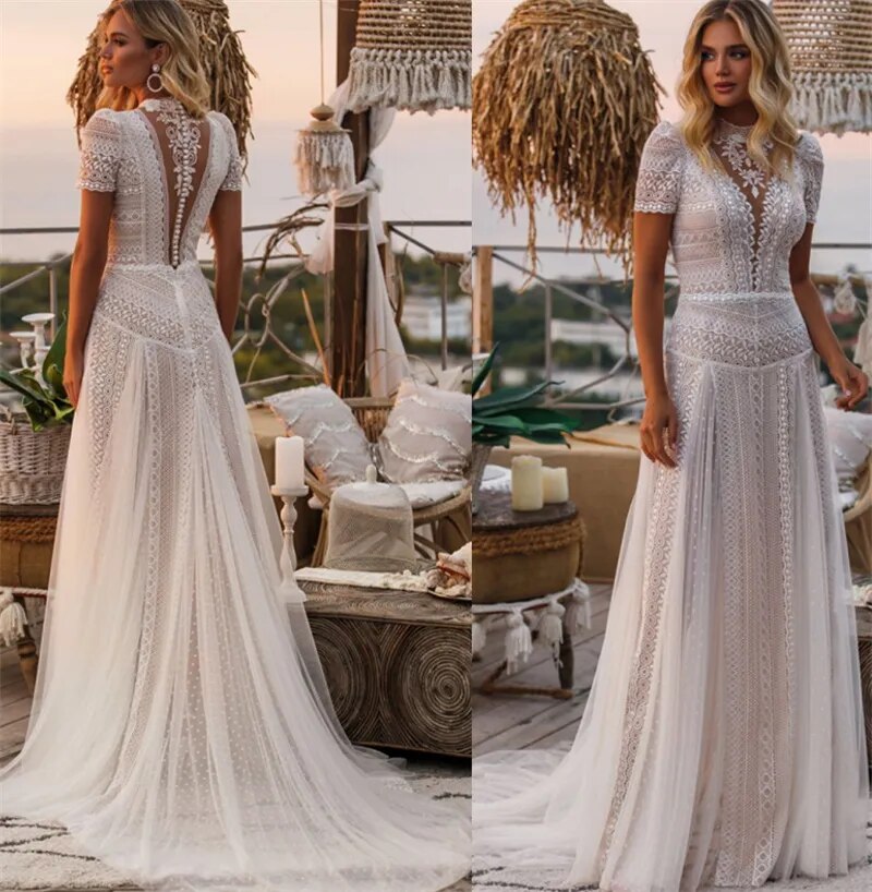 Back view of a bohemian wedding dress, showing lace appliques and court train.