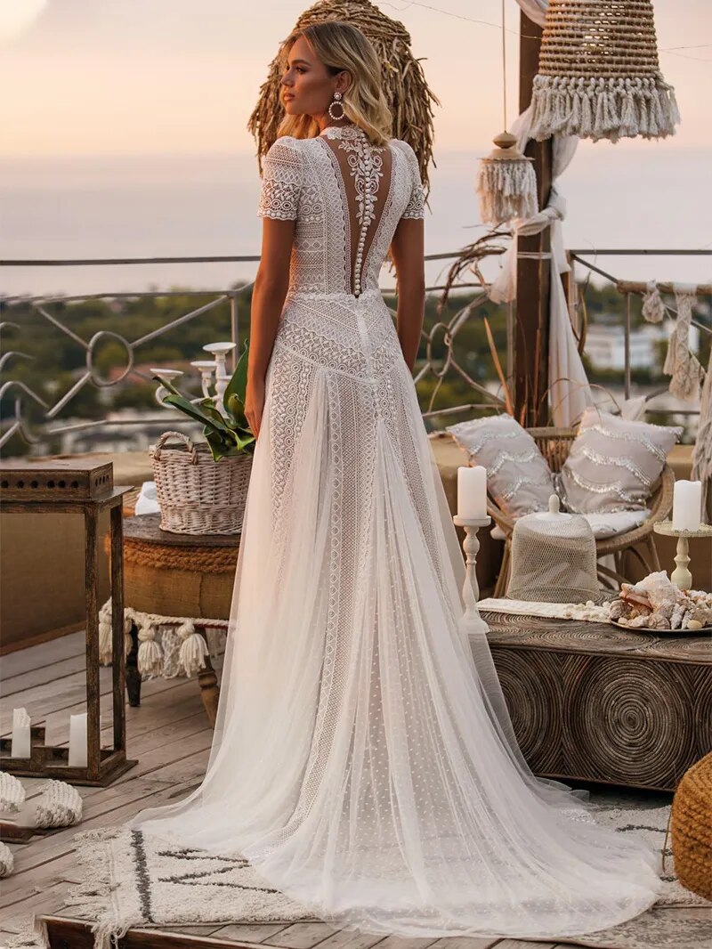 Side profile of an A-line bridal gown with illusion neck and short sleeves.