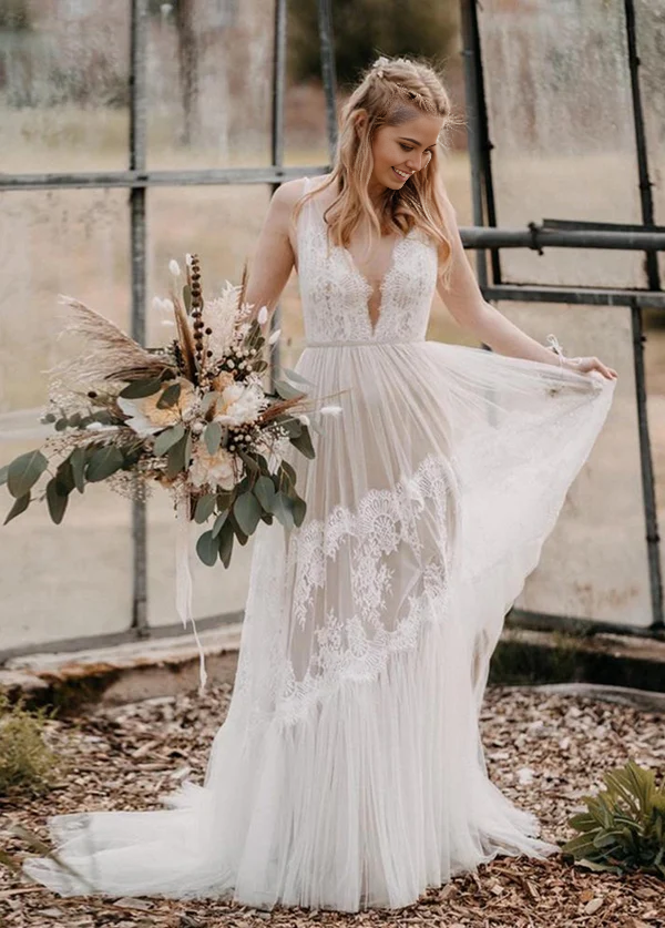 Model wearing a white Bohemian V-neck backless A-line wedding dress.