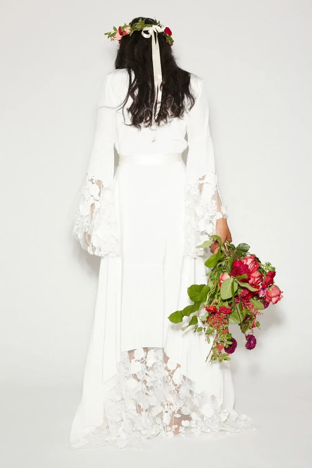 Elegant Bohemian A-line bridal gown with long lace sleeves.