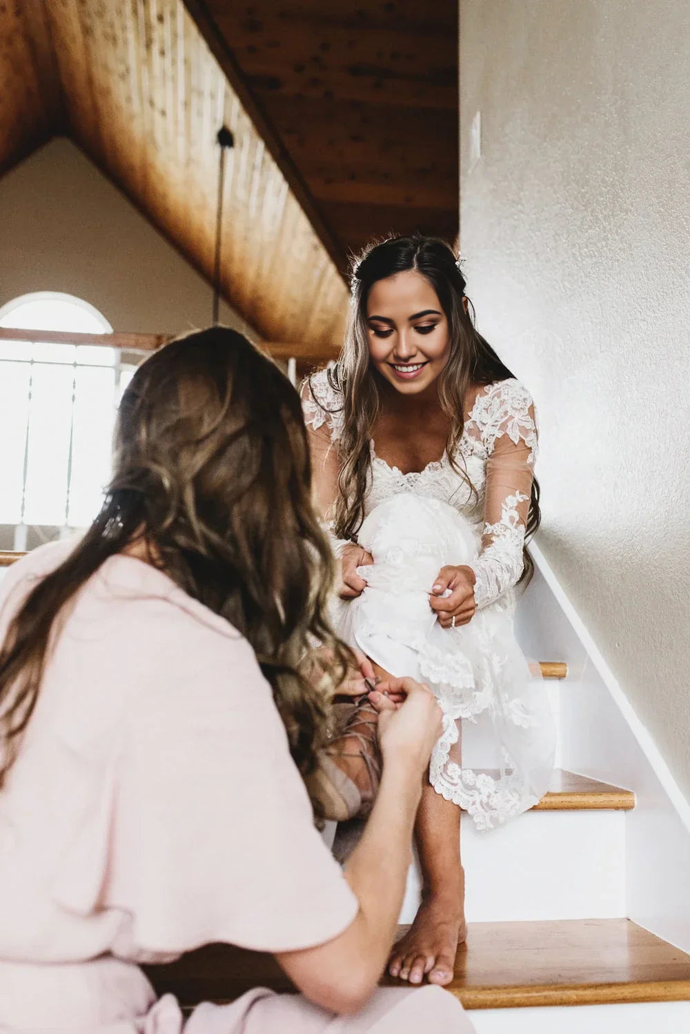Front view of a Bohemian A-line lace wedding dress with a deep V-neckline and cathedral train.