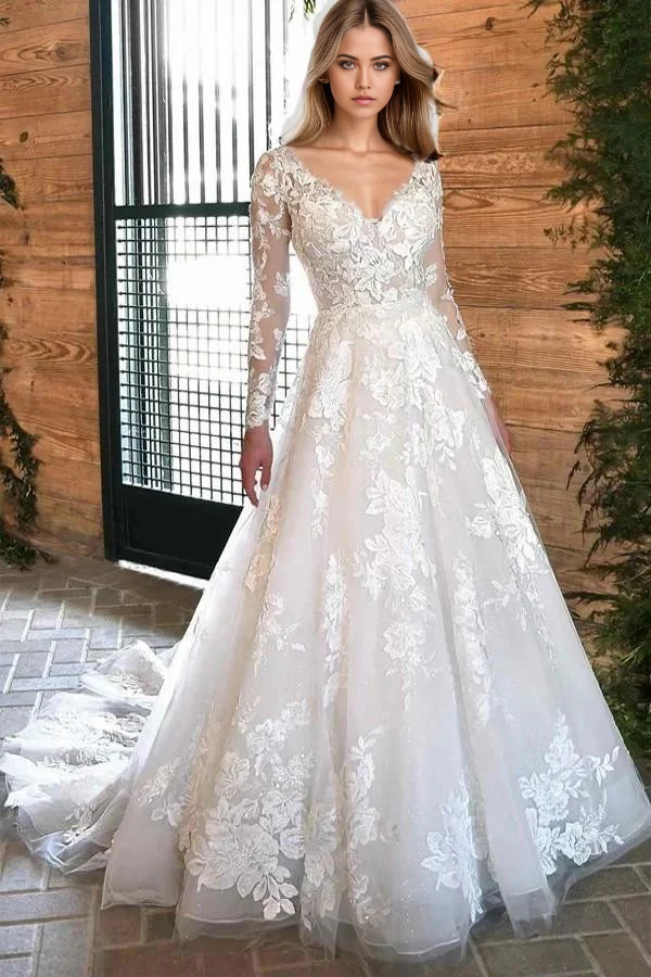 Bohemian A-line ivory lace wedding dress with long sleeves and V-neck.