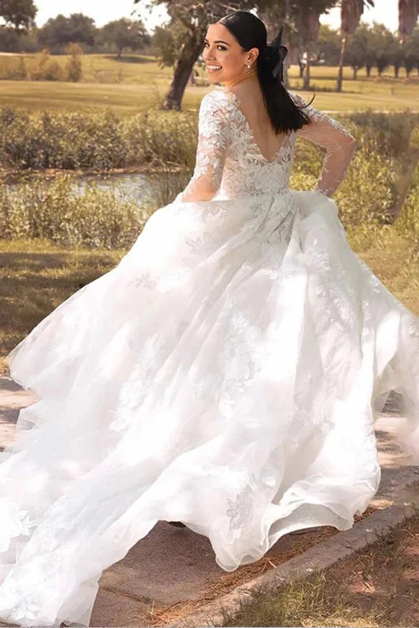 Bride wearing a country style ivory lace wedding gown with A-line silhouette.