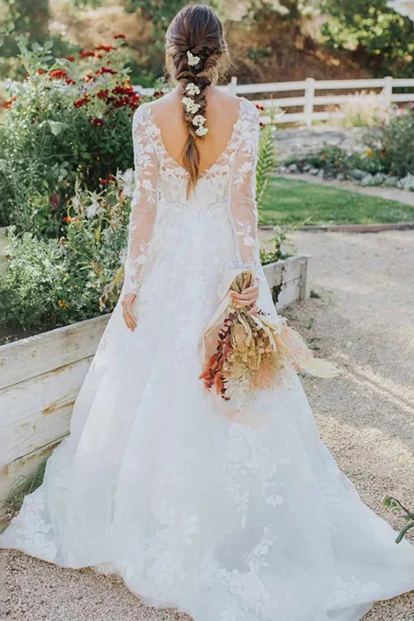 Full view of a Bohemian ivory lace wedding dress with long sleeves.