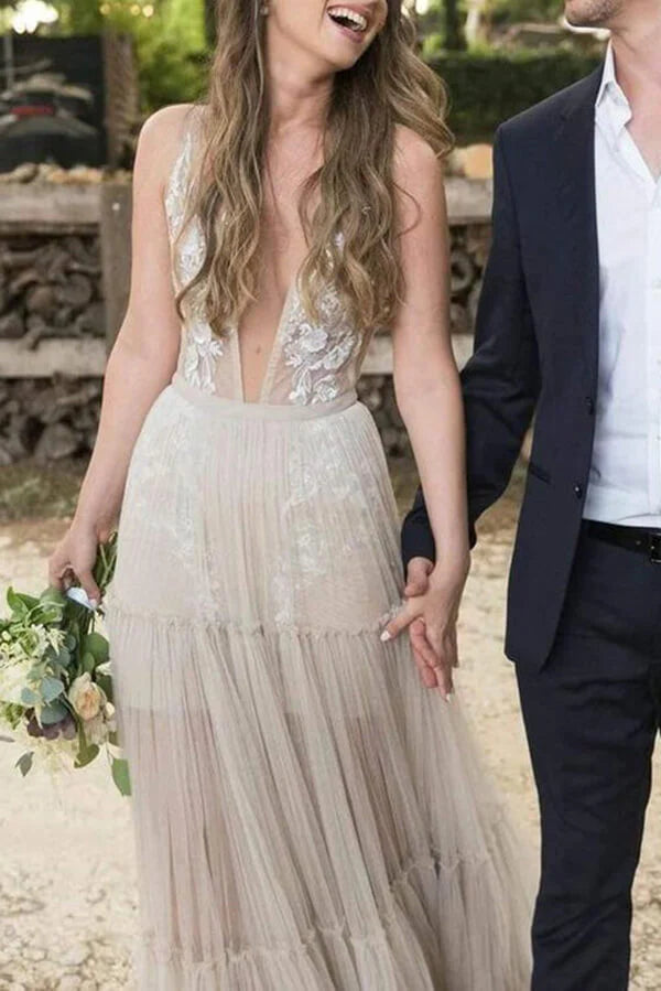 Bohemian A-line V-neck tulle wedding dress with delicate appliques.