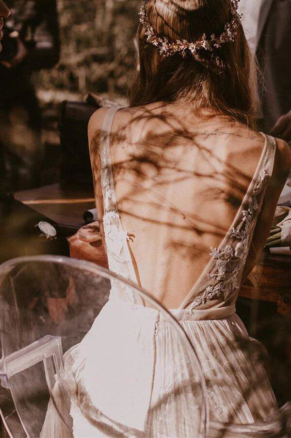 Front view of a romantic A-line tulle wedding dress with V-neck and appliques.