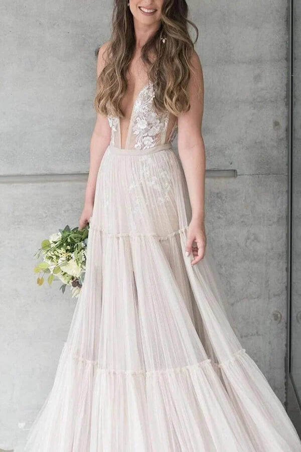 Stunning Bohemian wedding dress with A-line cut, V-neckline, and floral appliques.