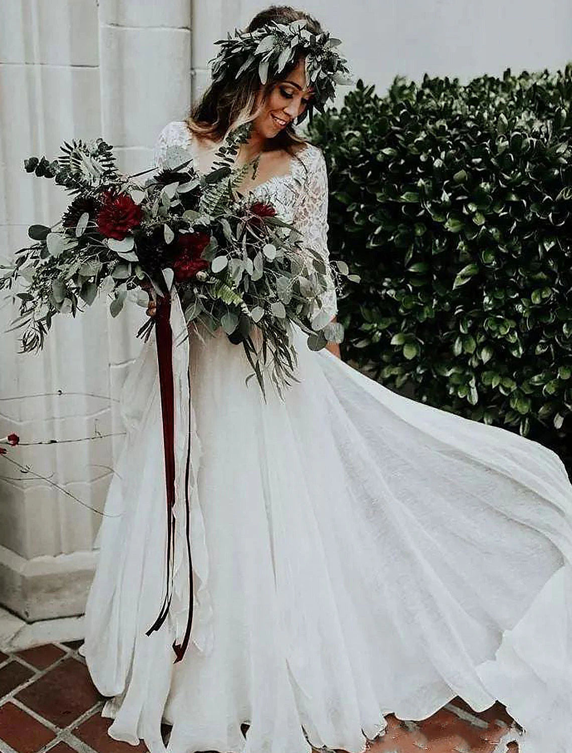 Back view of bohemian wedding dress showing sweep train and pleats.