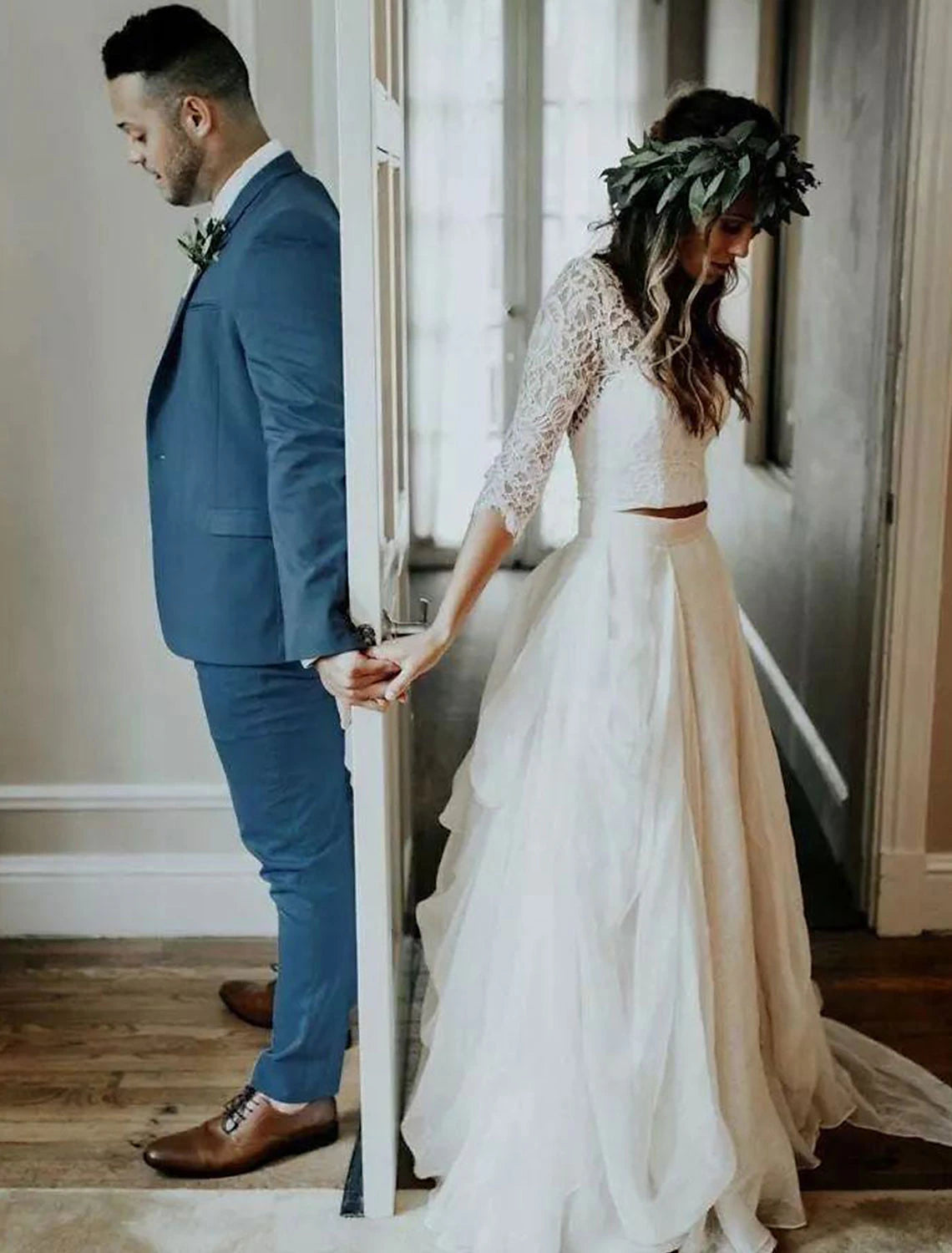 Model wearing a bohemian V-neck 3/4 sleeve chiffon bridal gown.