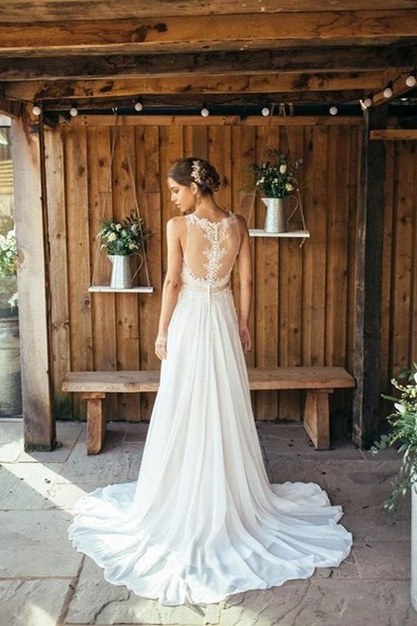 Back view of the ivory lace wedding gown with a flowing train.
