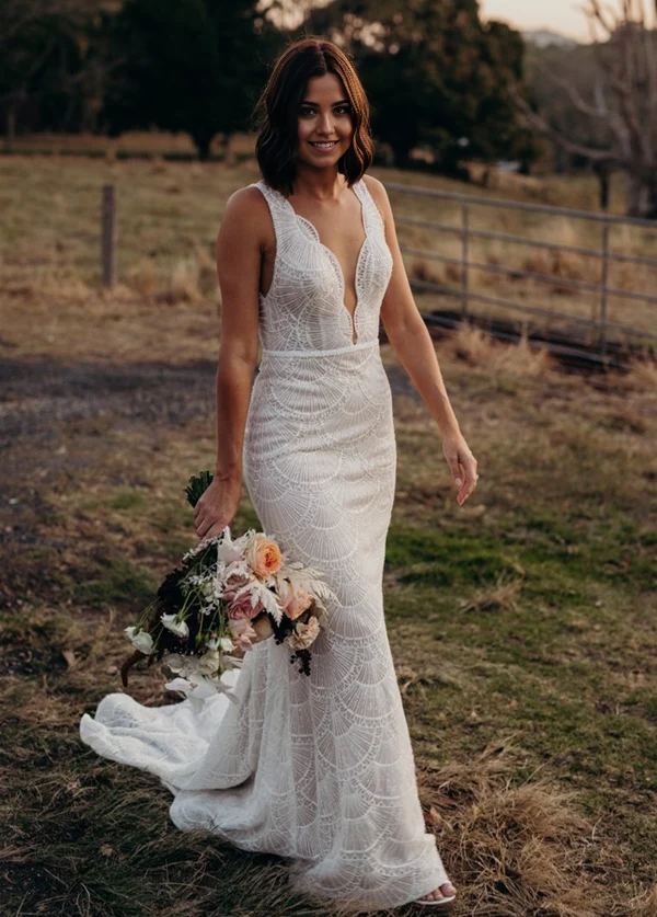 Model wearing a Bohemian Mermaid V-neck backless lace wedding dress.