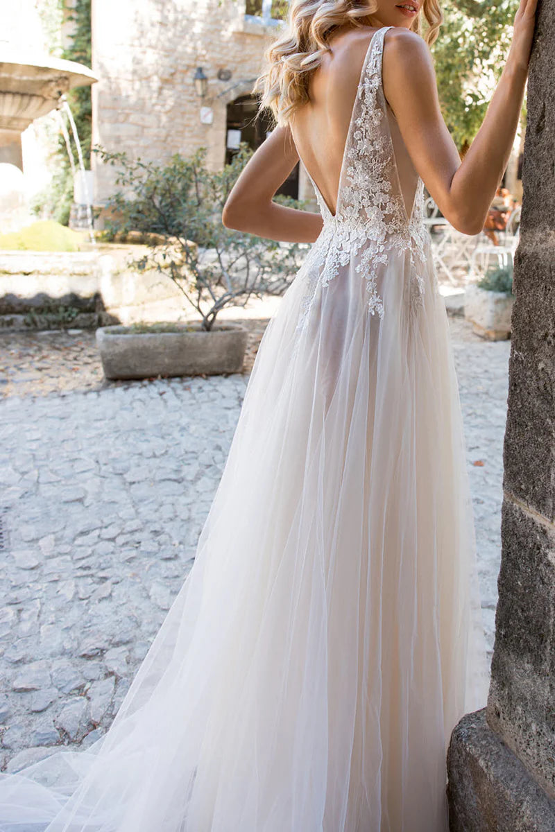 Bride wearing a romantic A-line wedding dress with intricate lace details.