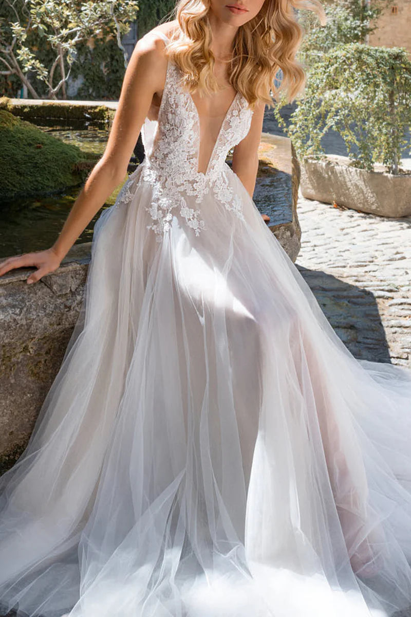 Close-up of lace appliques on a deep V-neck bohemian wedding gown.