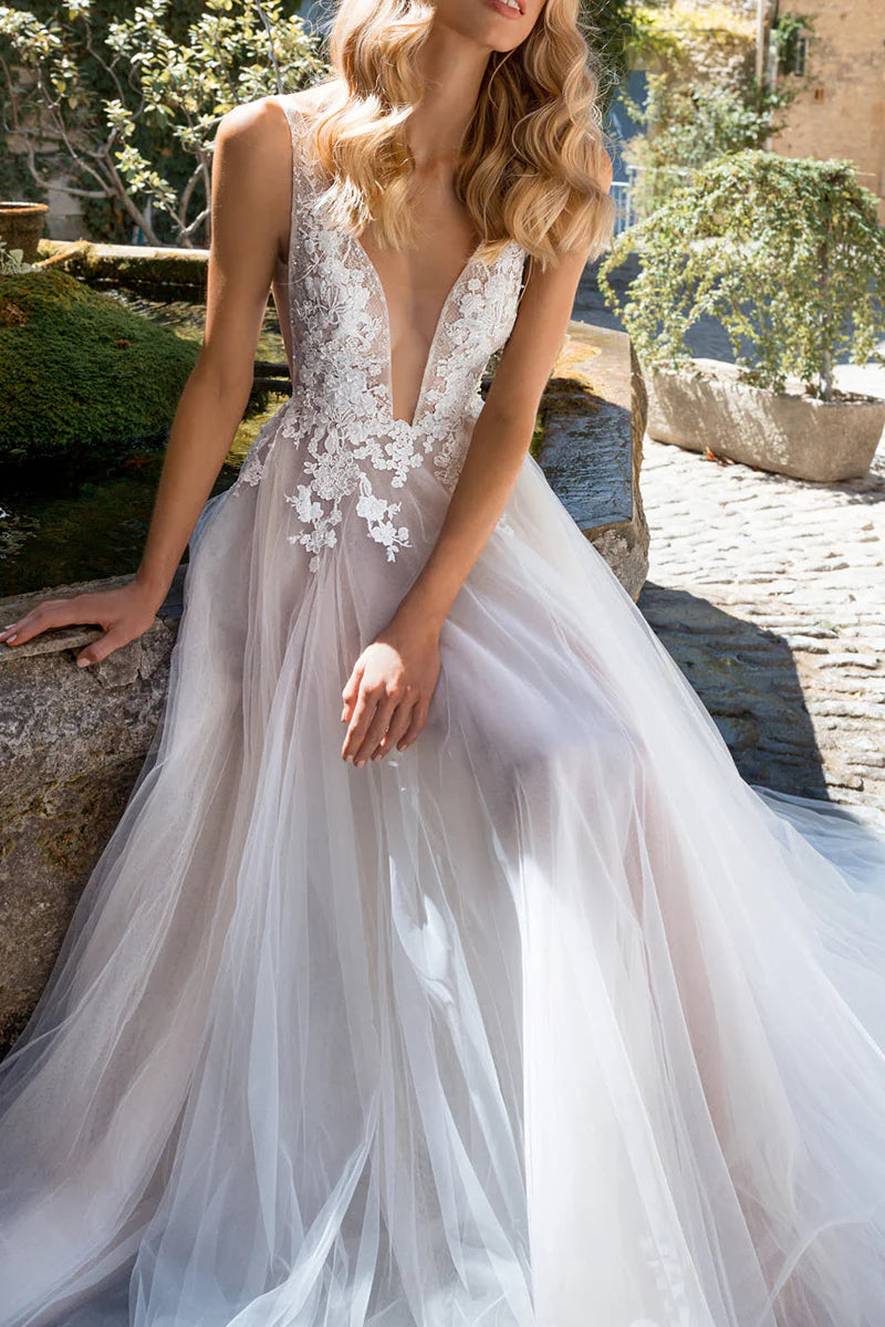 Full view of a bride in a flowing A-line boho wedding dress.