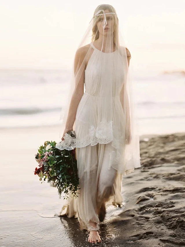 Back view of a flowing chiffon wedding dress with court train.