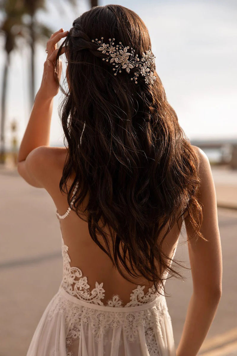Side profile of a bride wearing a flowing A-line lace wedding dress, ideal for beach ceremonies.