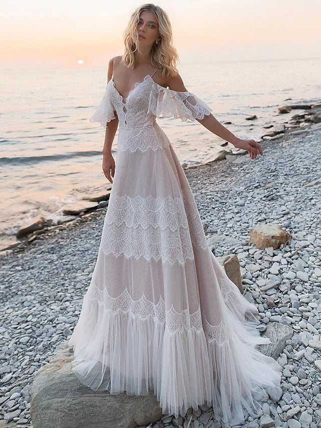 Boho A-line lace wedding dress with V-neck, short sleeves, and open back.