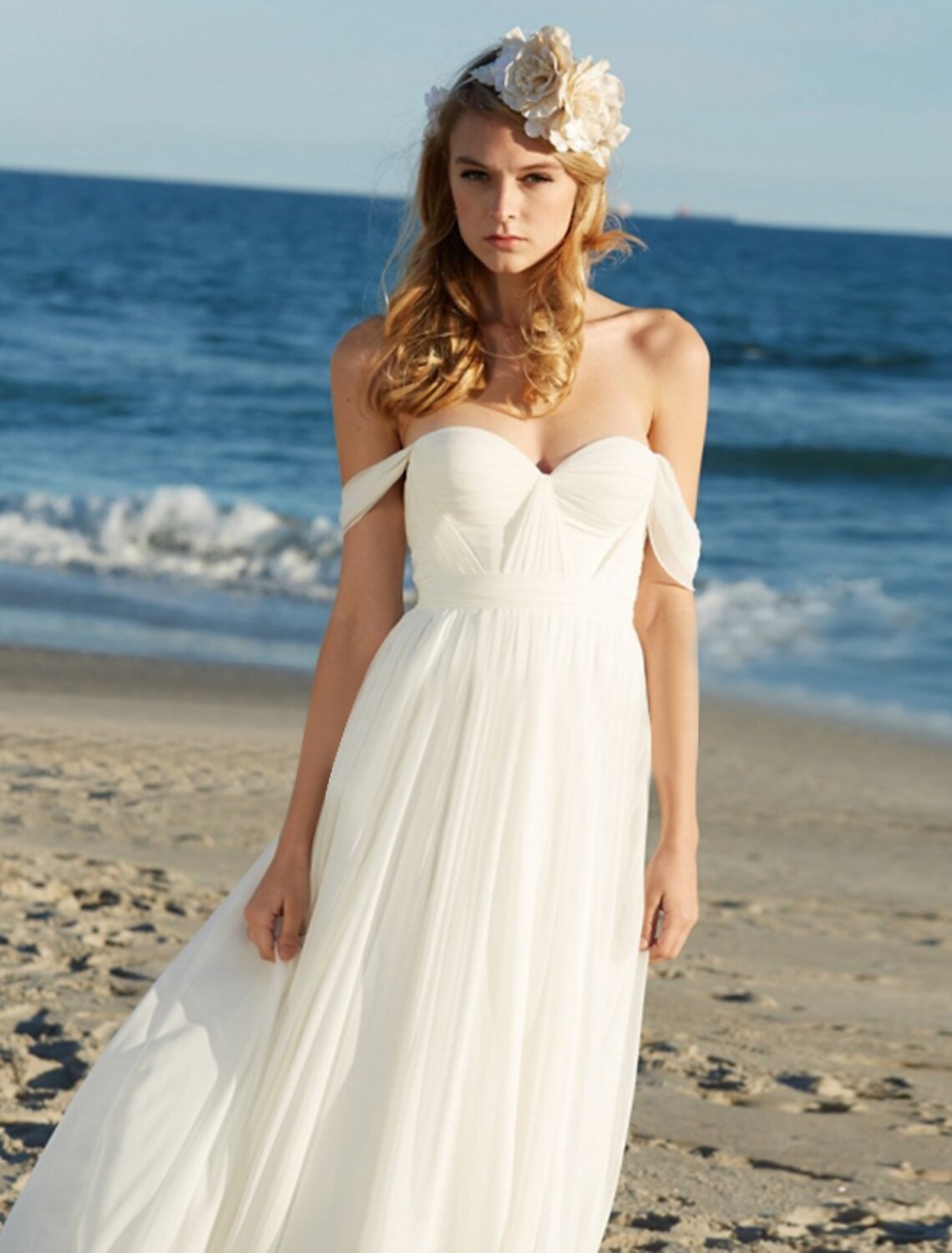 Back view of a floor-length A-line bridal gown with flowing chiffon.