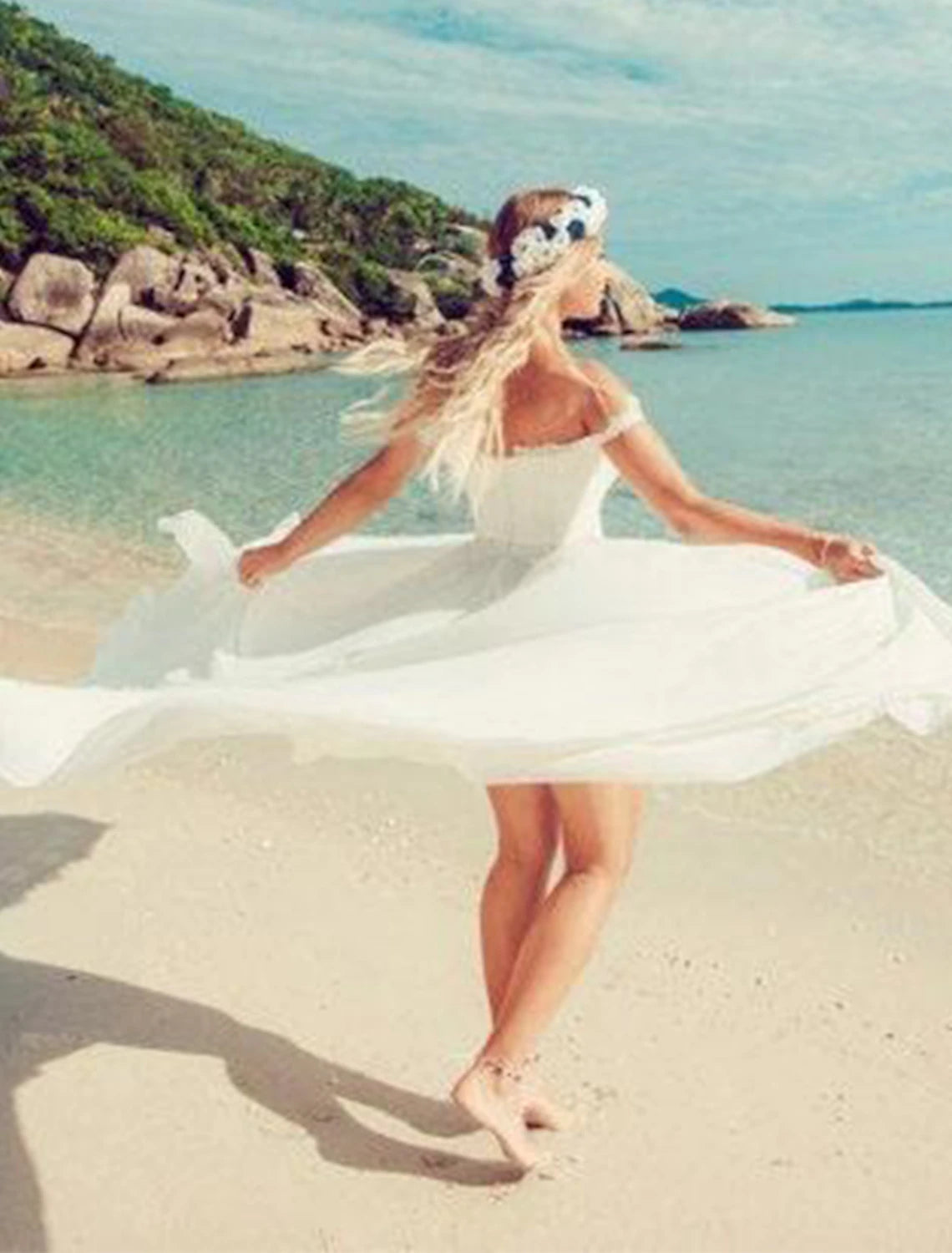 Side view of a flowing chiffon wedding dress with off-shoulder neckline.
