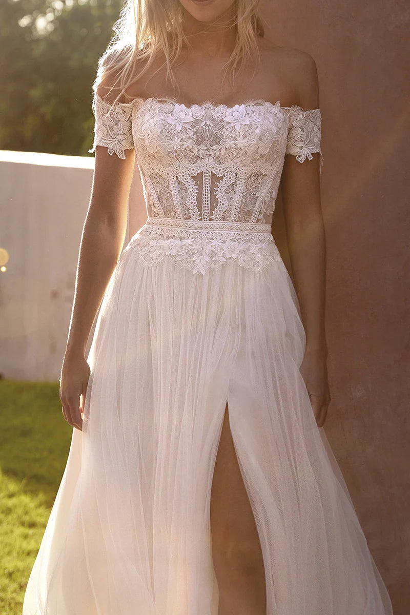 Close-up of the delicate lace and off-shoulder neckline on the boho wedding dress.
