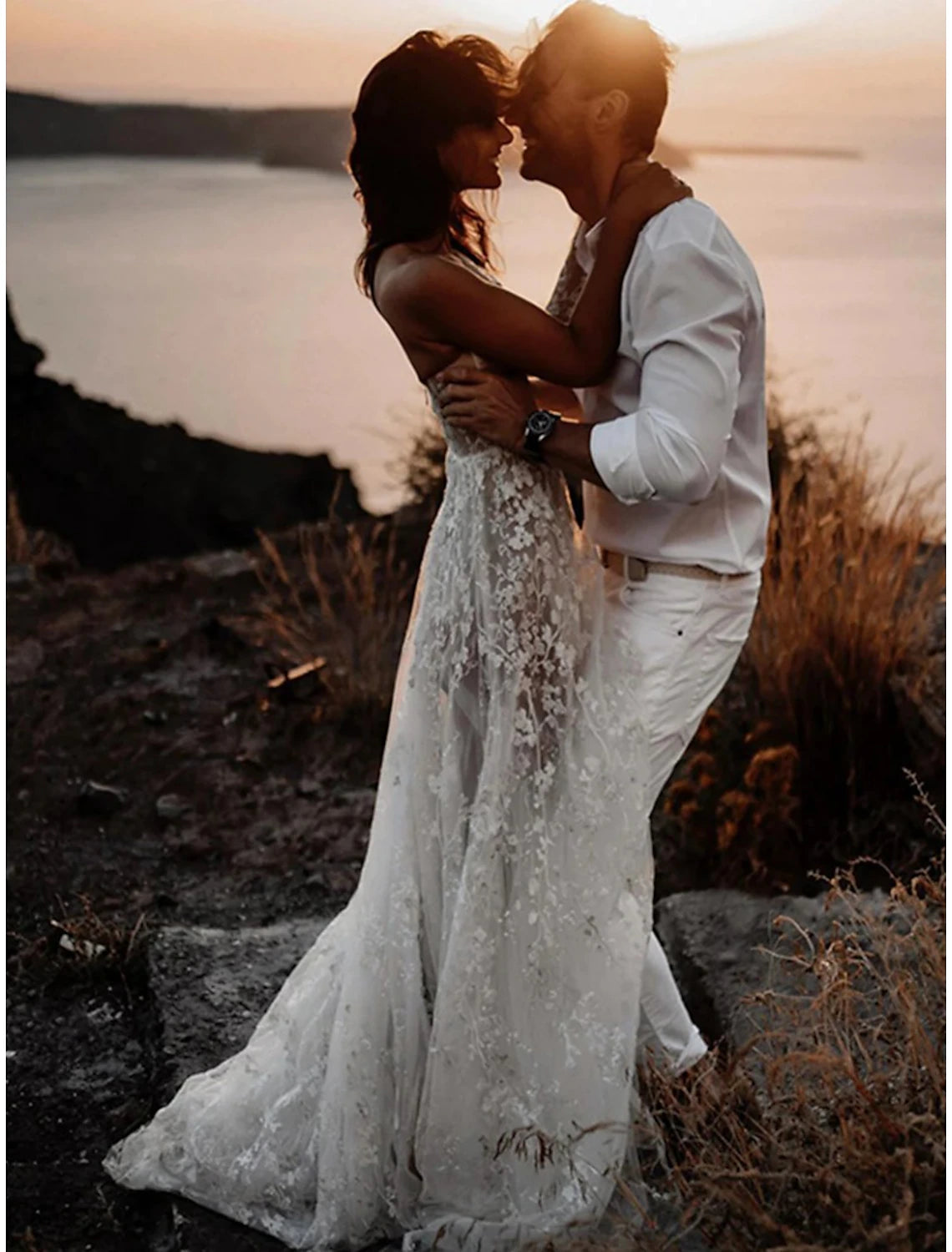 Side view of the A-line one-shoulder long-sleeve lace wedding dress, showing the sweep train.