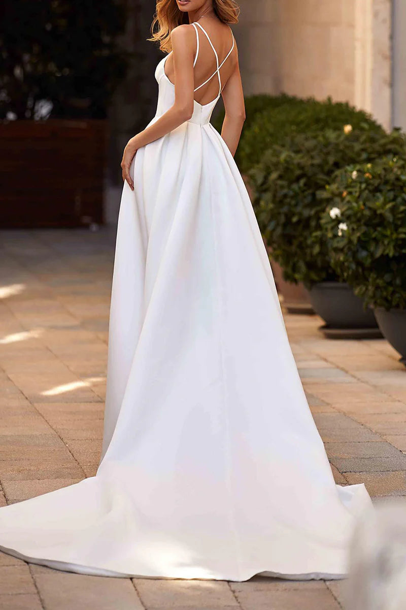 Close-up of the V-neckline and spaghetti straps of the satin wedding dress.