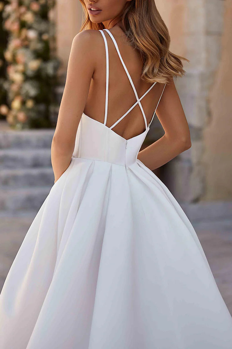 Side profile of the model in the Boho satin wedding dress, highlighting the slit.