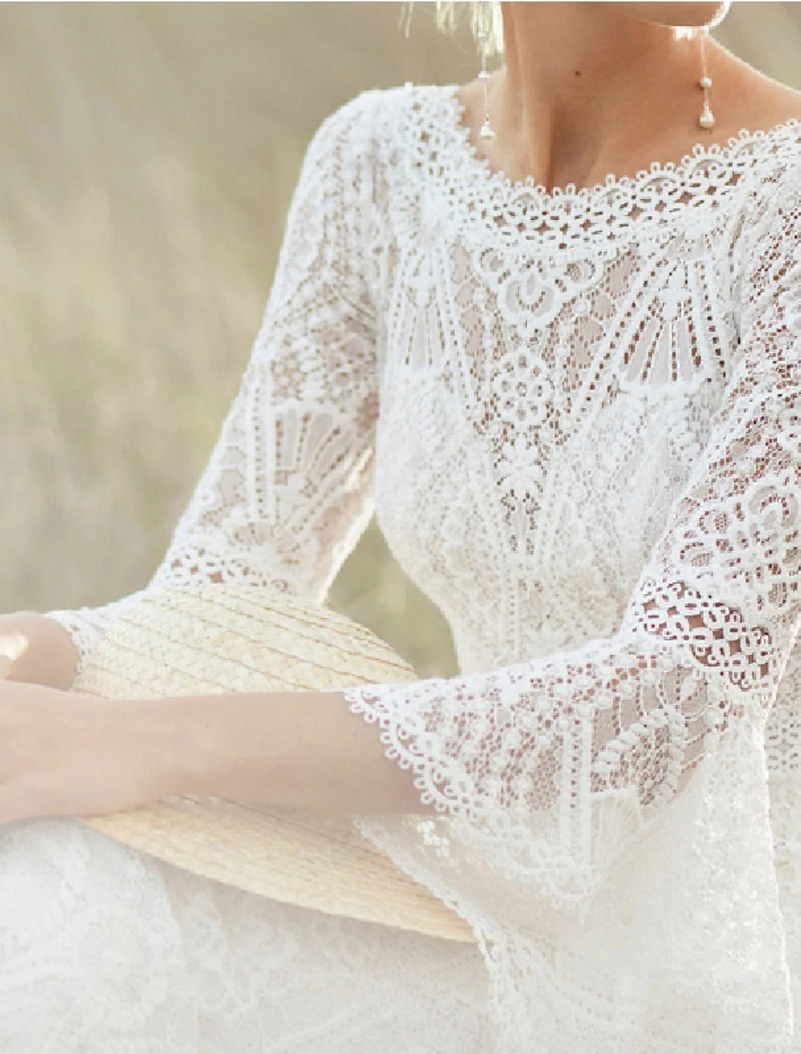 Back view of a bride wearing a lace wedding gown with a sweep train.