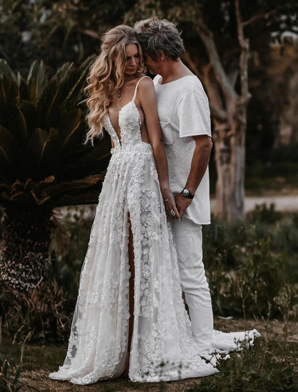 Close-up of lace appliques and split front detail on a bridal gown.