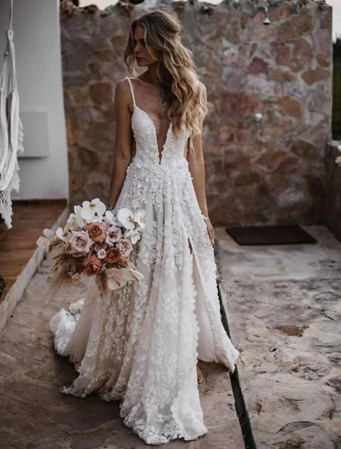 Full length view of a bride wearing a boho A-line wedding dress.