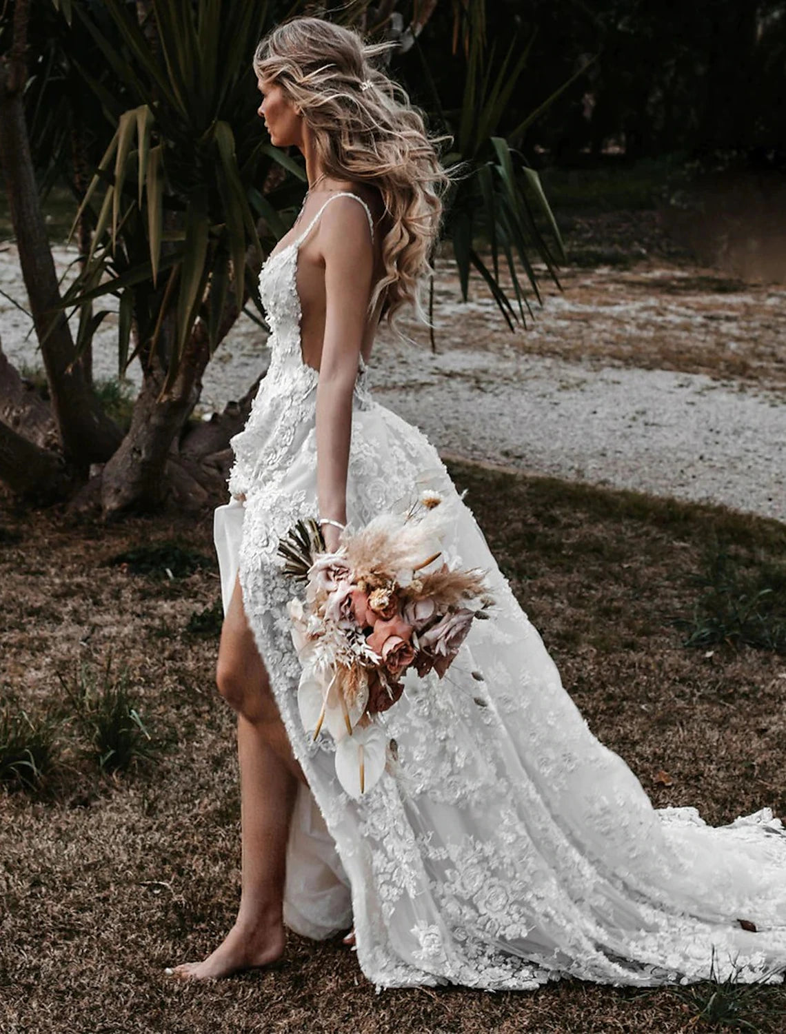 Side profile of the boho wedding dress, highlighting the flowing silhouette.