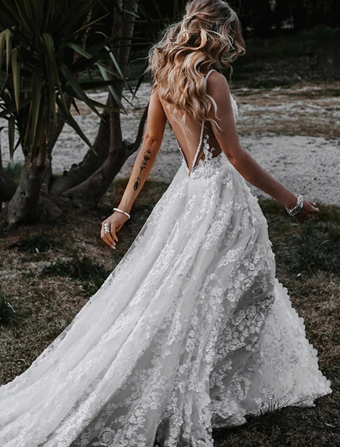 Boho wedding dress with sweetheart neckline and elegant flowing skirt.