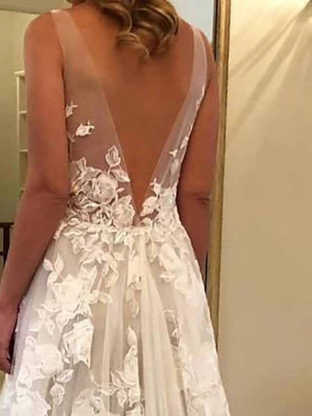 Side view of a bride wearing a bohemian A-line wedding dress.