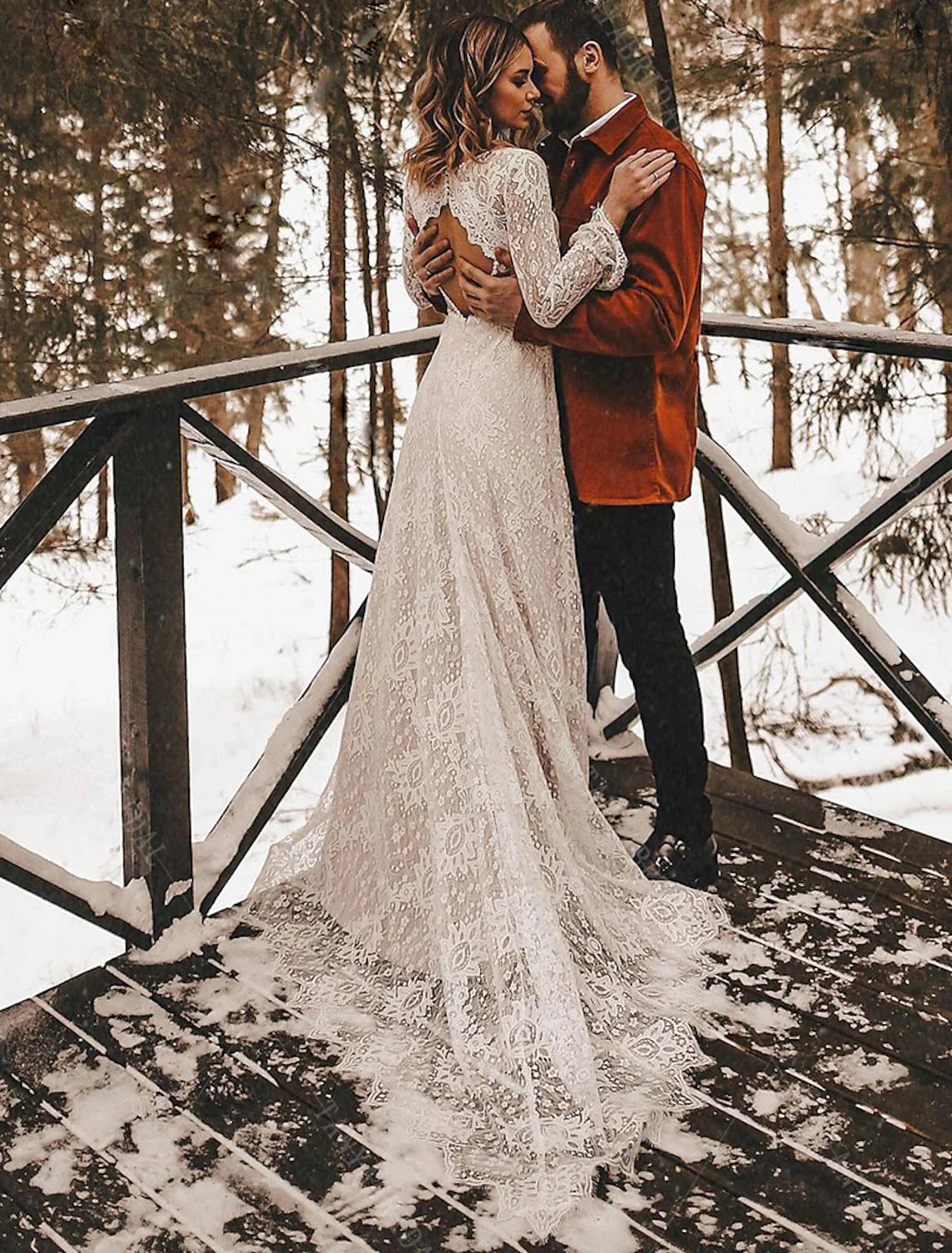 Close-up of the V-neckline and intricate lace on the long sleeves of the wedding dress.