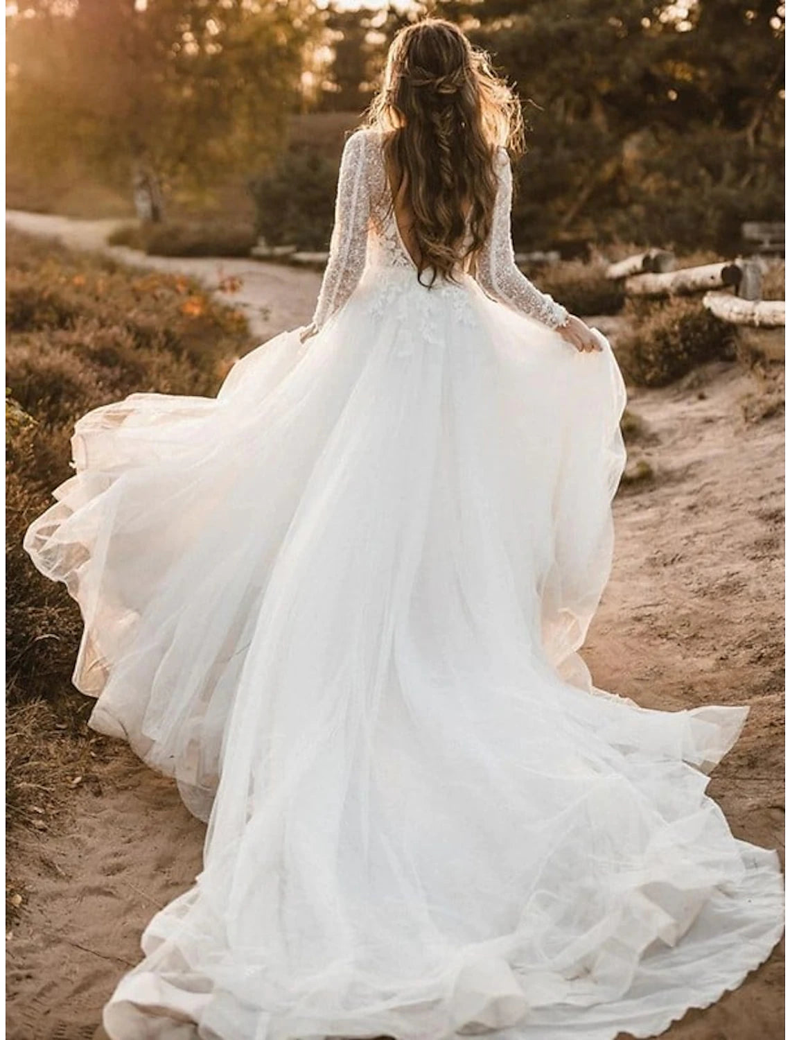 Close-up of the V-neckline and lace long sleeves on the boho wedding dress.