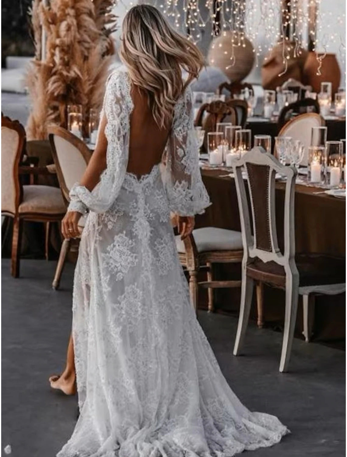 Close-up of the lace and applique details on the long sleeve of the wedding gown.