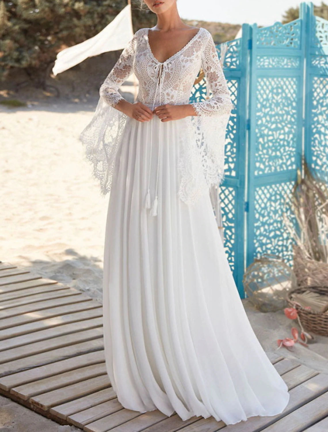 Front view of V-neck long sleeve chiffon bridal gown.