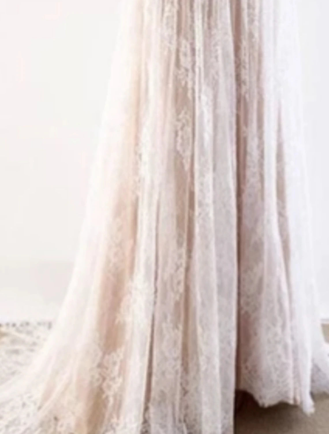 Side view of a bohemian A-line wedding dress with short sleeves.