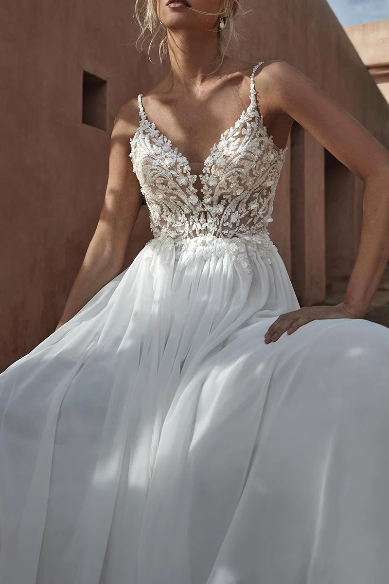 Close-up of delicate lace appliques on the V-neck wedding dress.