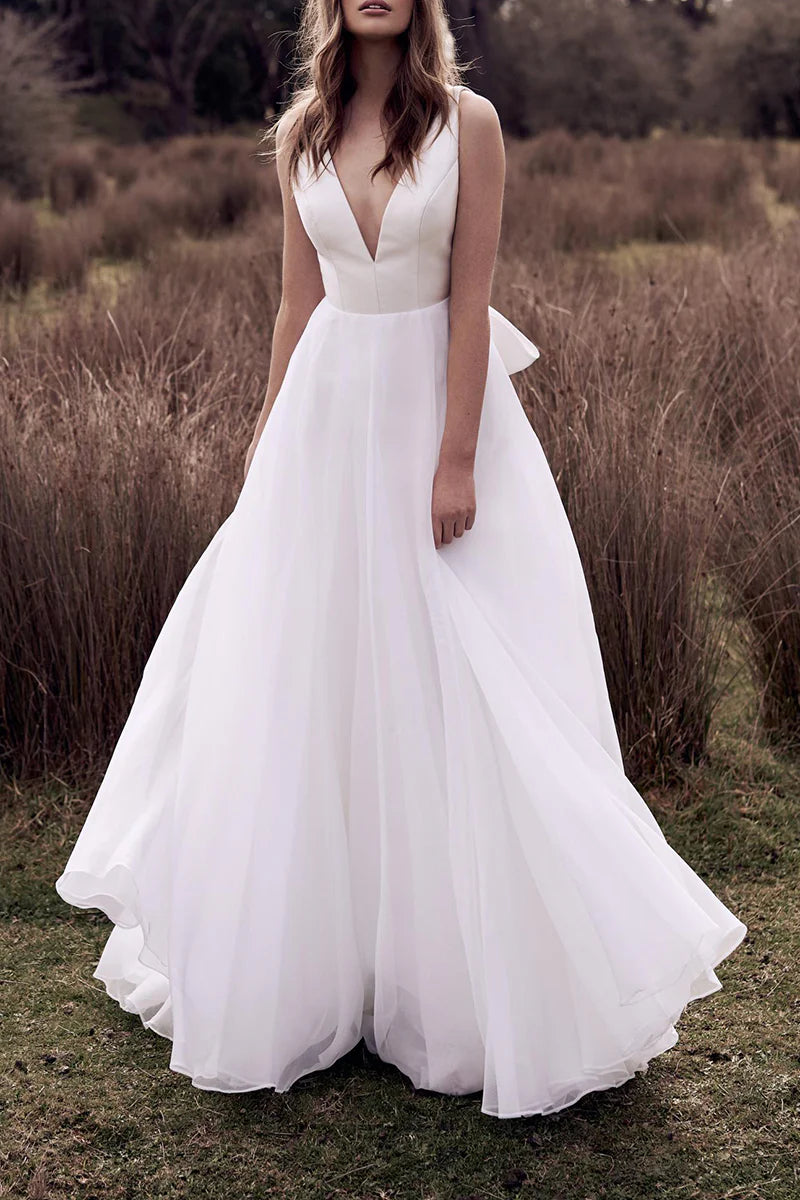 Boho A-line wedding dress with deep V-neck and open back, front view.