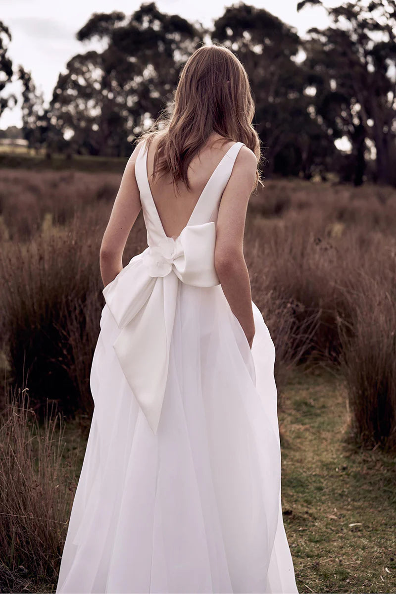 Back view of a sleeveless boho wedding dress, showcasing the simple open back.