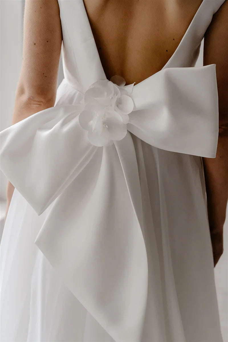 Full length view of a model wearing the sleeveless A-line wedding dress.