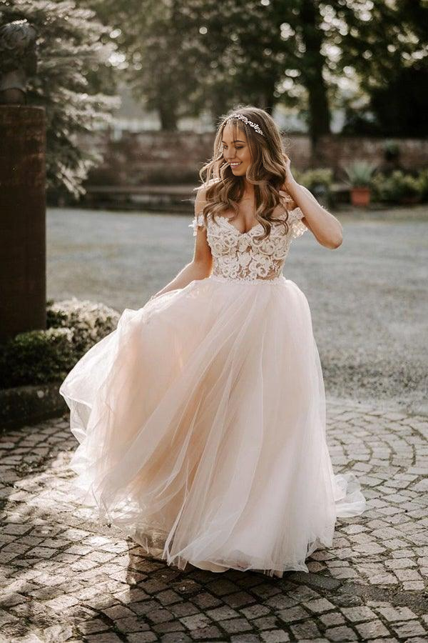 Boho A-line champagne wedding dress with off-the-shoulder neckline, front view.