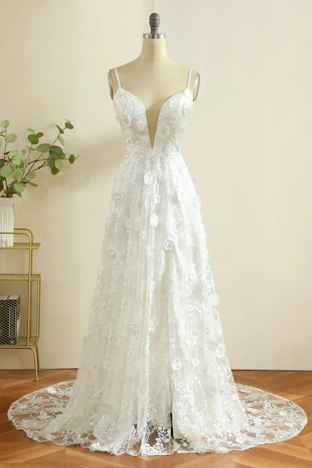 White boho wedding dress with spaghetti straps and a front slit.