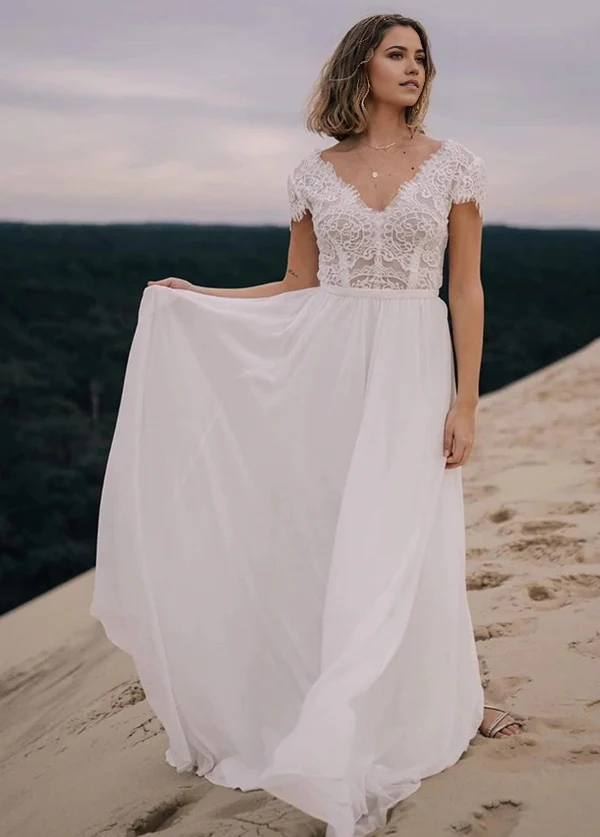 Boho A-Line V-Neck wedding dress with chiffon and lace details on a model.