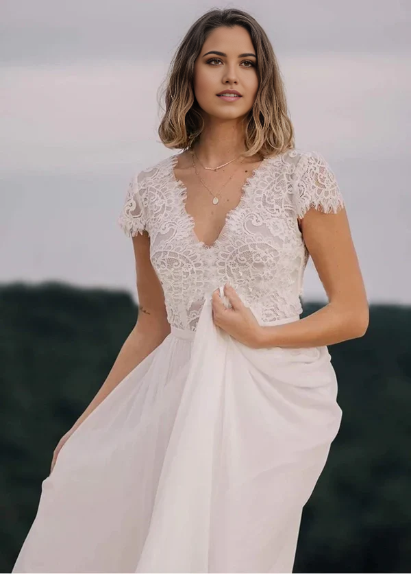 Close-up of the V-neckline and lace bodice details of the wedding dress.