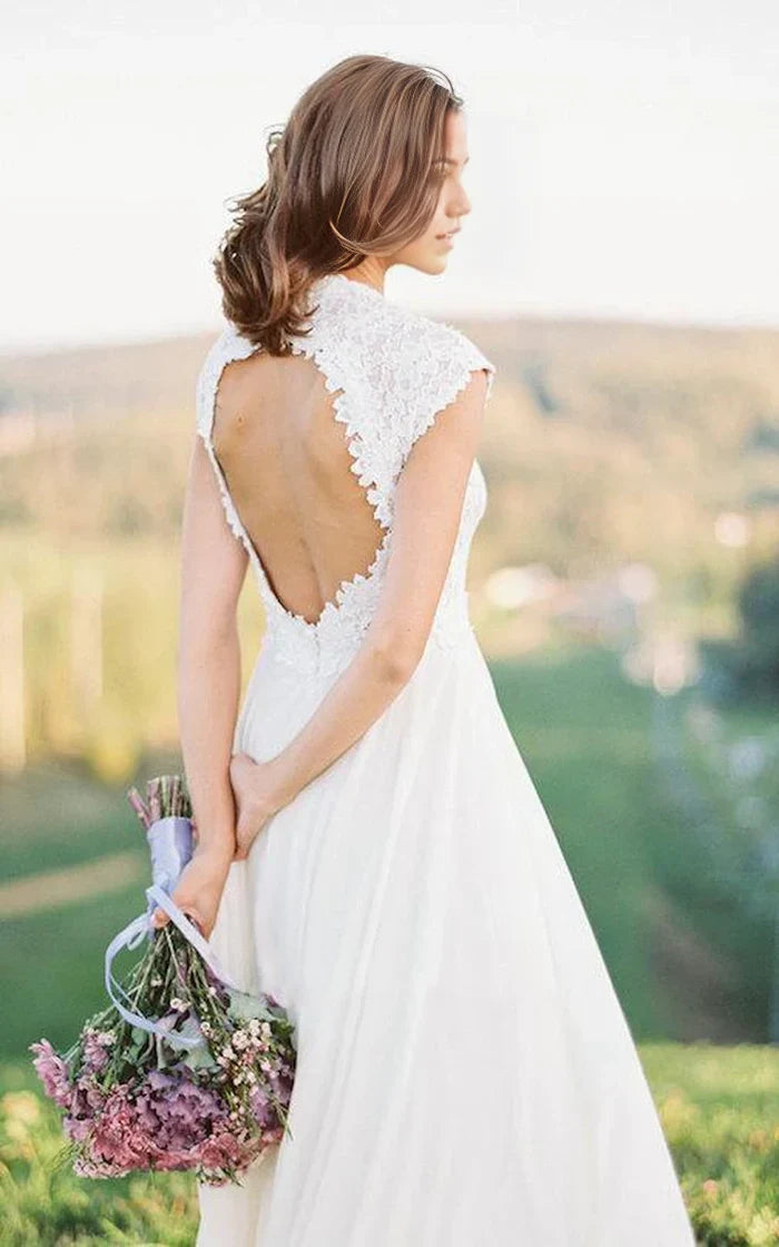 Close-up of the lace detail on the bodice and cap sleeve of the wedding dress.