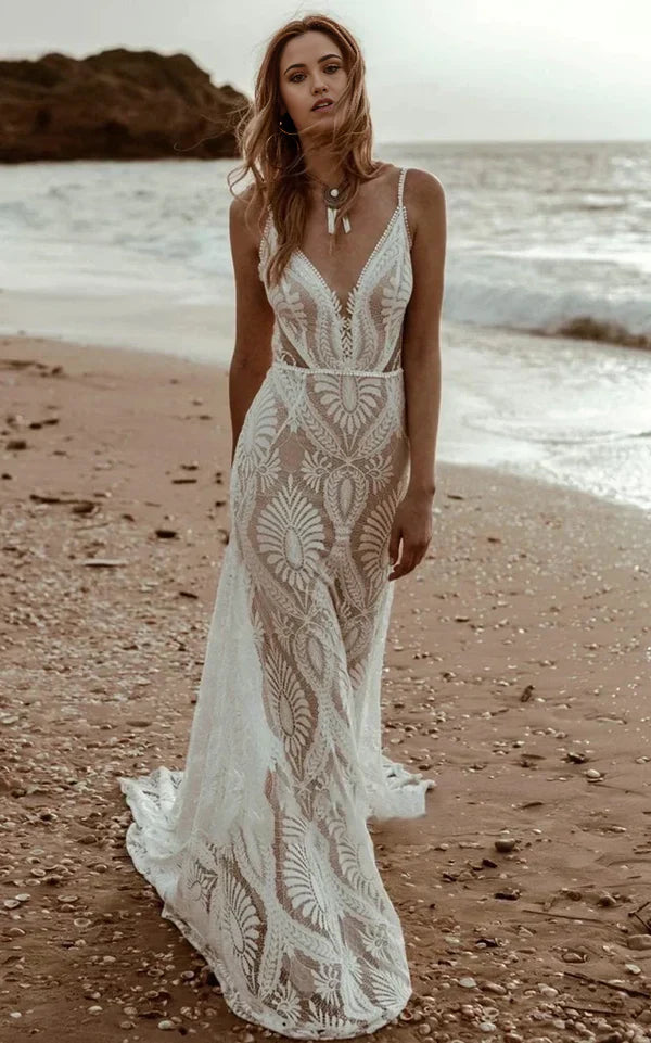 Boho mermaid wedding dress with plunging V-neck, lace details, and sweep train.